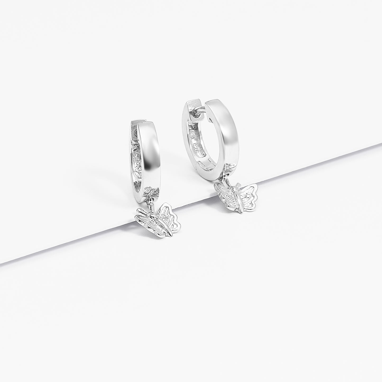 Sterling Silver Huggie Earrings With Dangling Butterfly