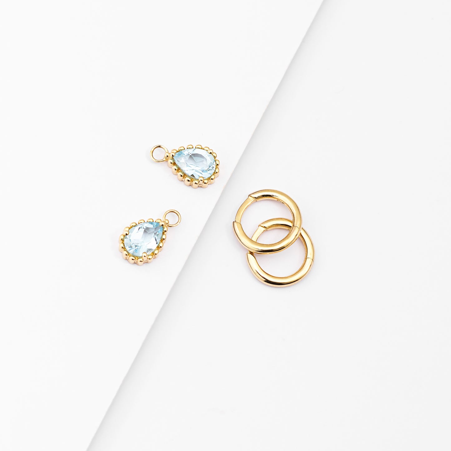 9K Yellow Gold Huggie Earrings With Dangling Blue Topaz Pear