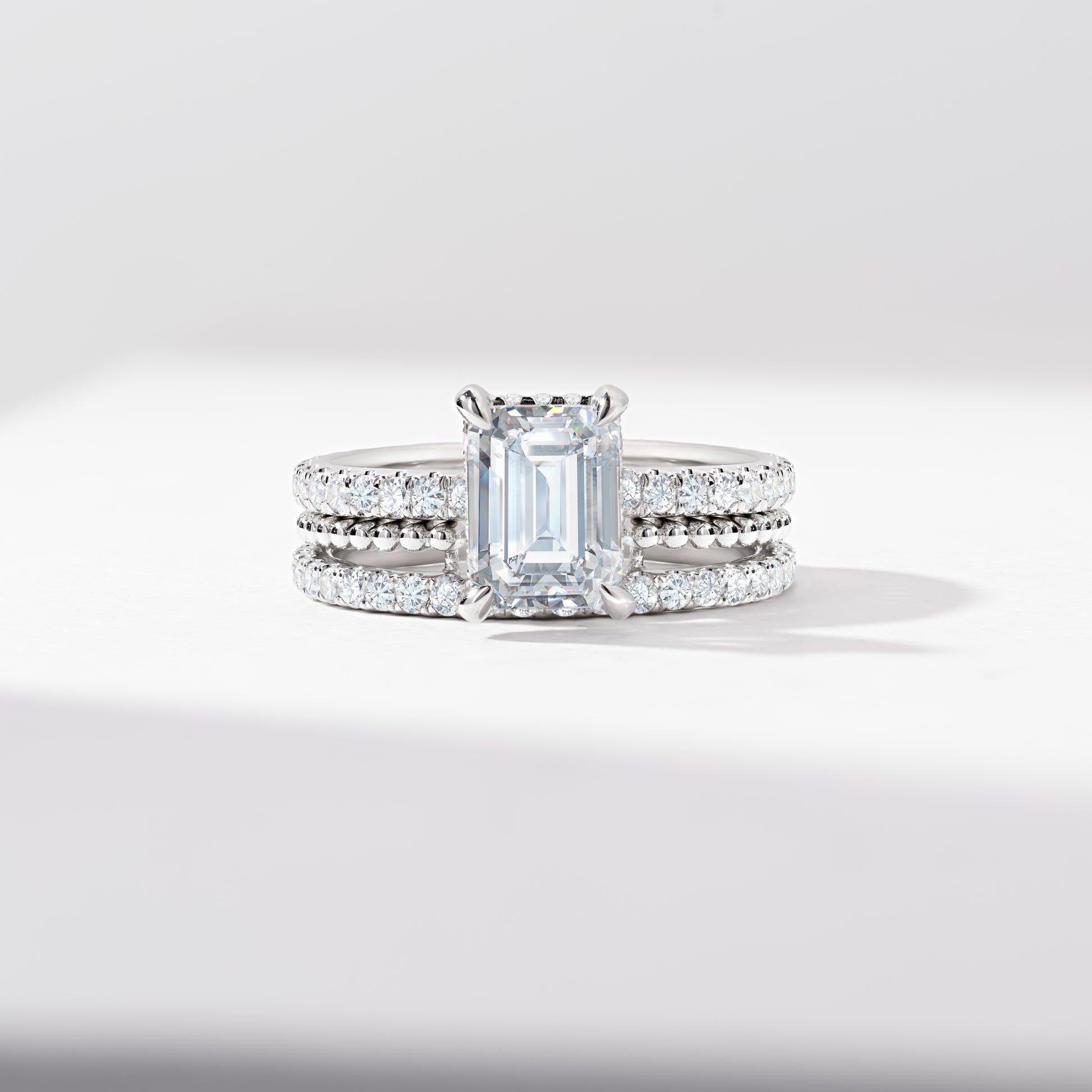 Emerald Cut Diamond Solitaire With Hidden Halo And Shoulders