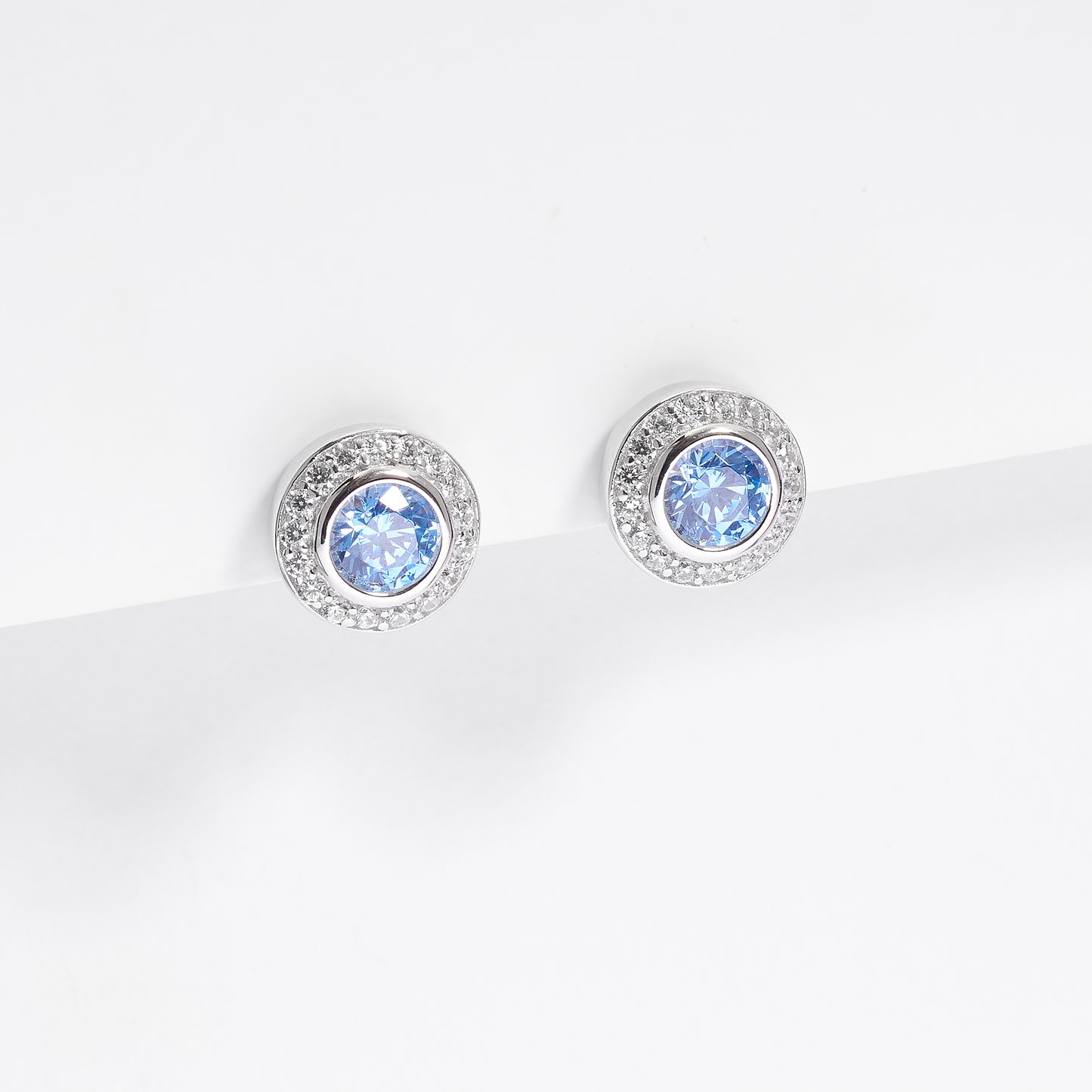 Sterling Silver Bezel Blue Zirconia Halo Stud Earrings