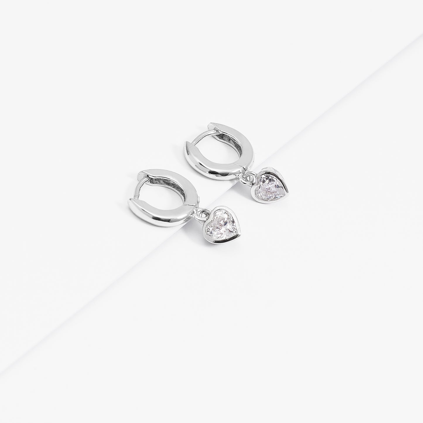 Sterling Silver Huggie Earrings With Dangling Zirconia Heart