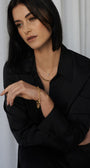 Model wearing the 9K yellow gold alternating oval and round link chain and matching bracelet