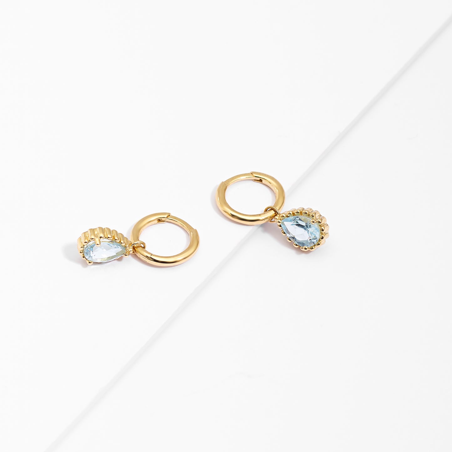 9K Yellow Gold Huggie Earrings With Dangling Blue Topaz Pear