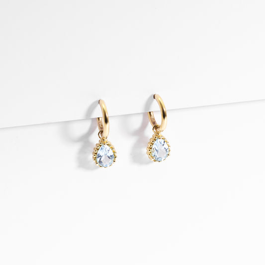 9K Yellow Gold Huggie Earrings With Dangling Blue Topaz Pear