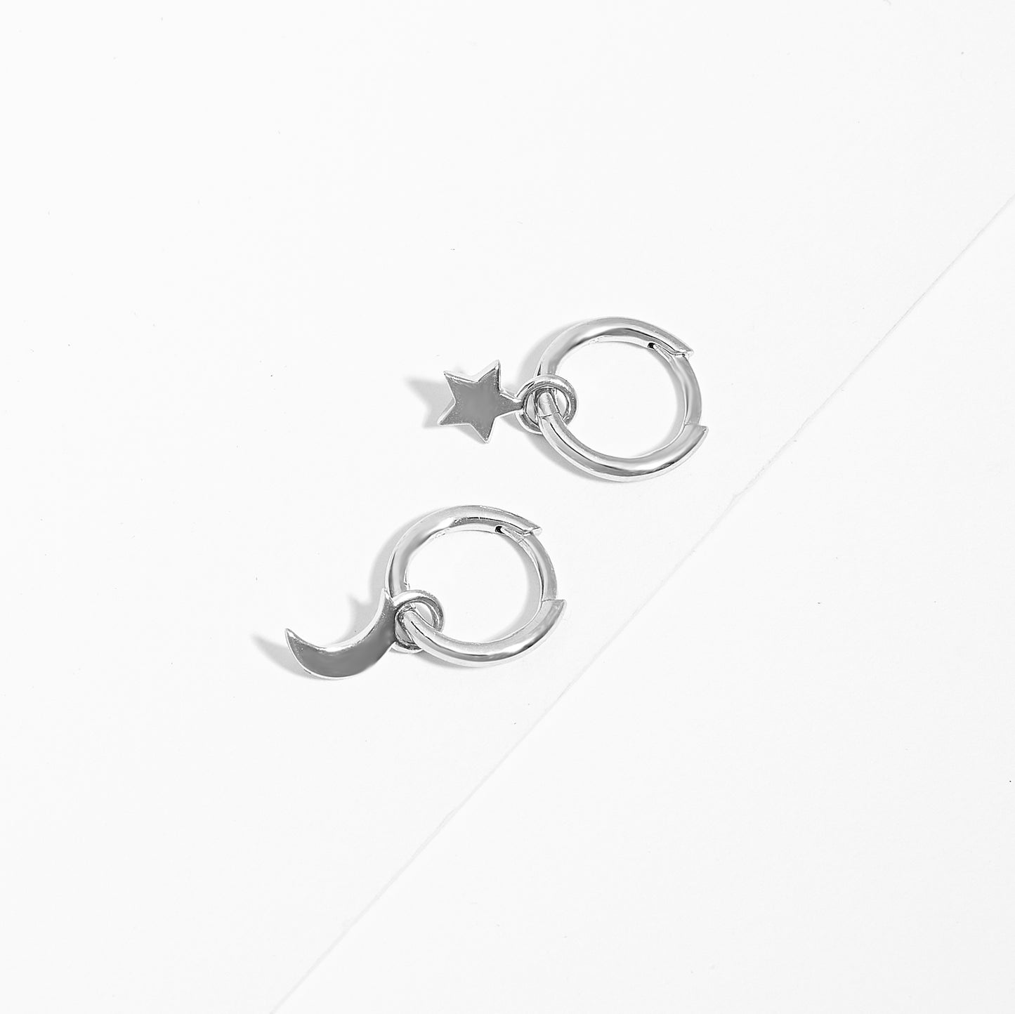 Sterling Silver Huggie Earrings With Dangling Star And Moon