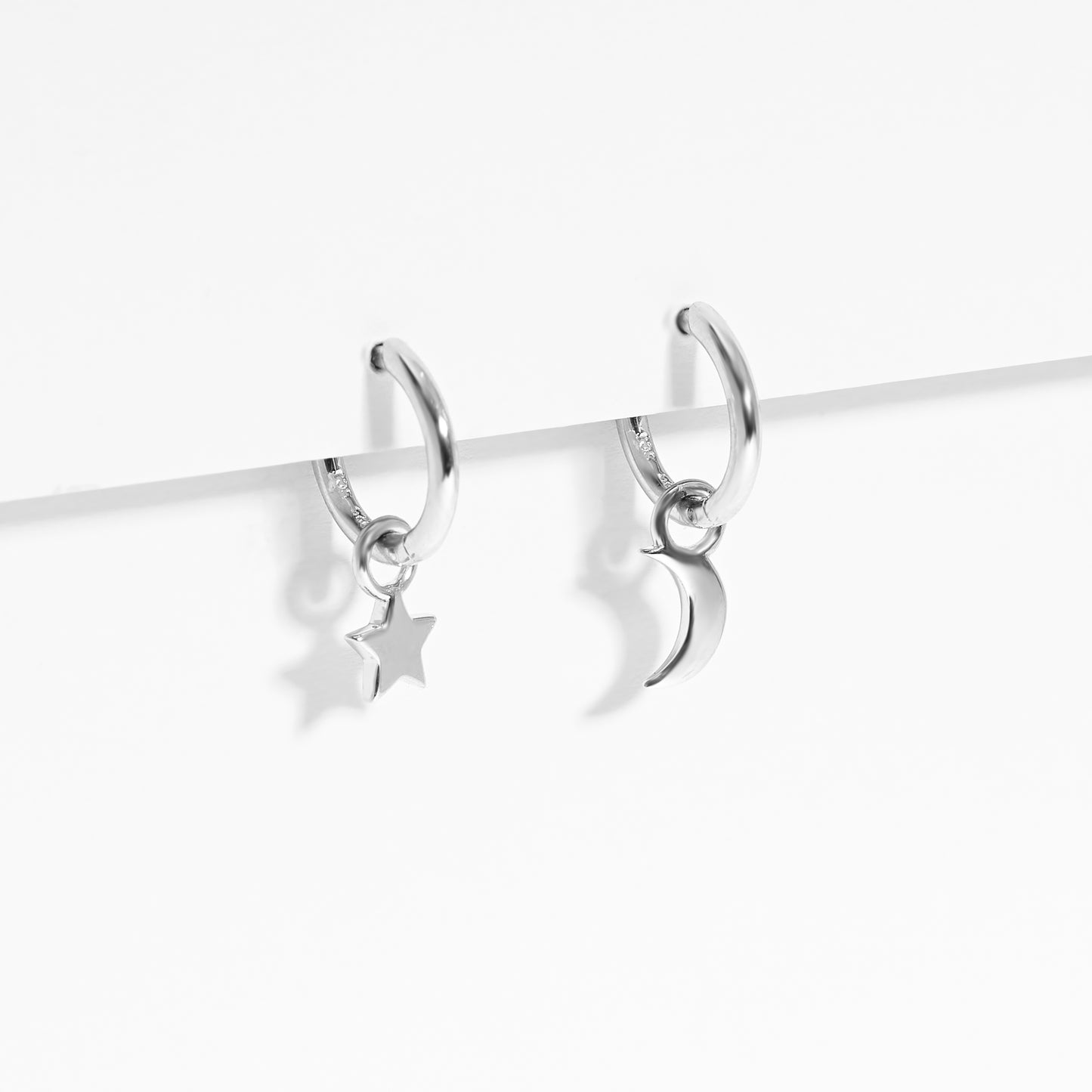 Sterling Silver Huggie Earrings With Dangling Star And Moon