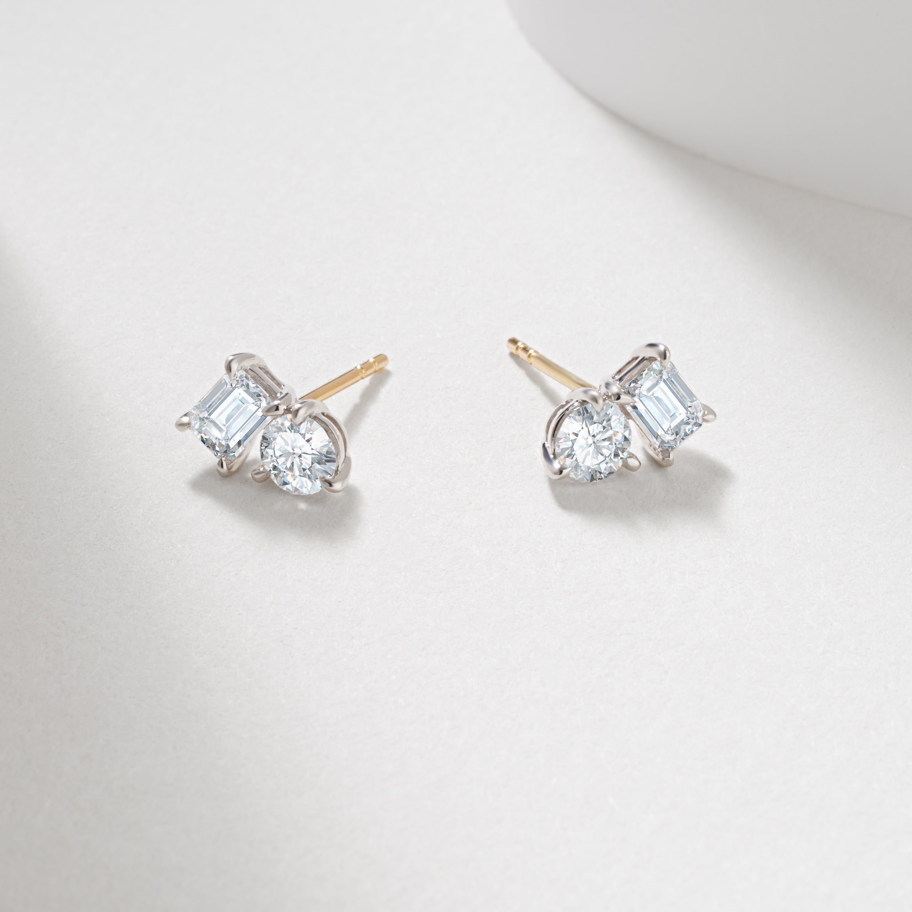 9WY 1.49tdw emerald and round lab diamond claw set toi et moi stud earrings