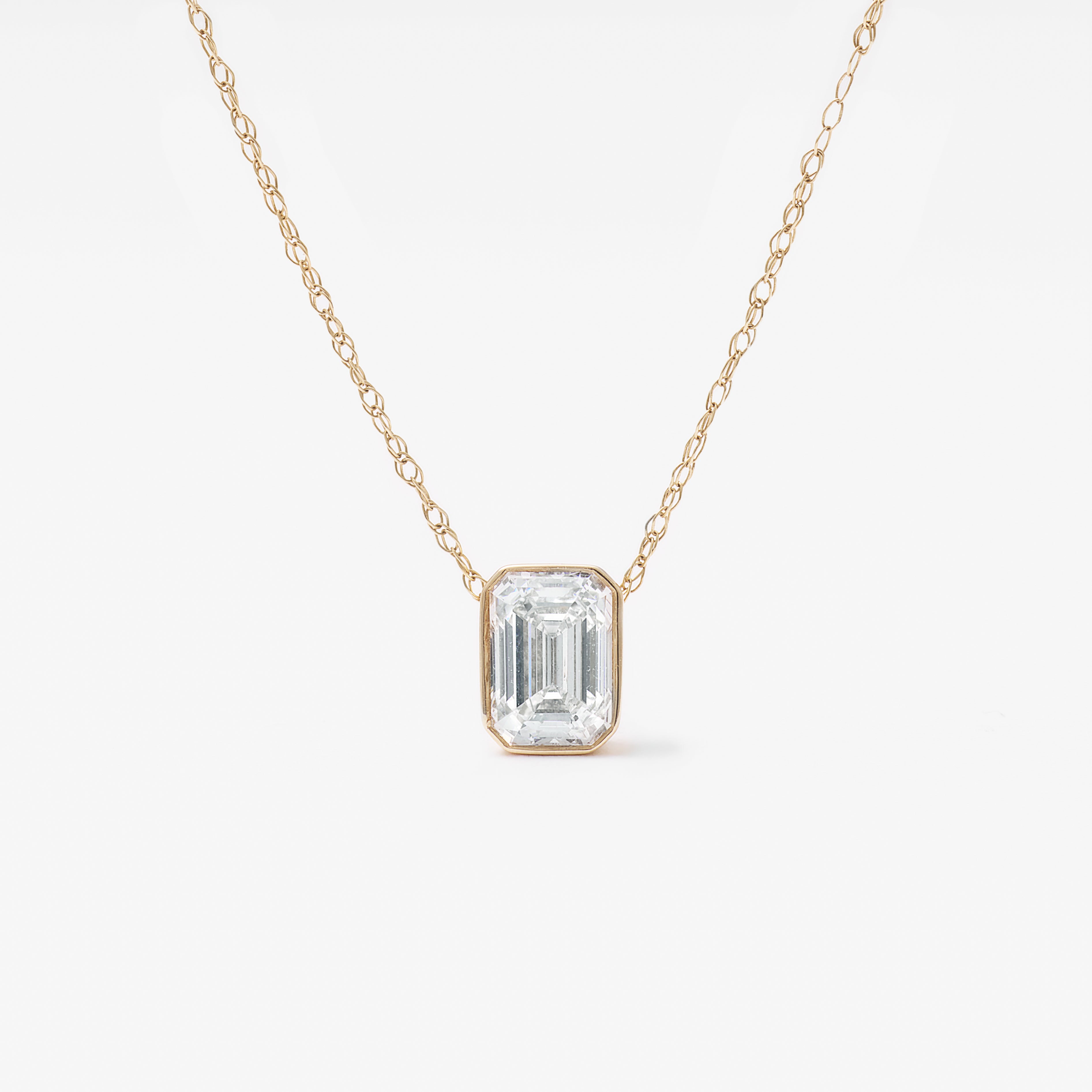 9K Yellow Gold 0.70ct Bezel Emerald Cut Lab Diamond Slider Pendant With Chain 45cm.