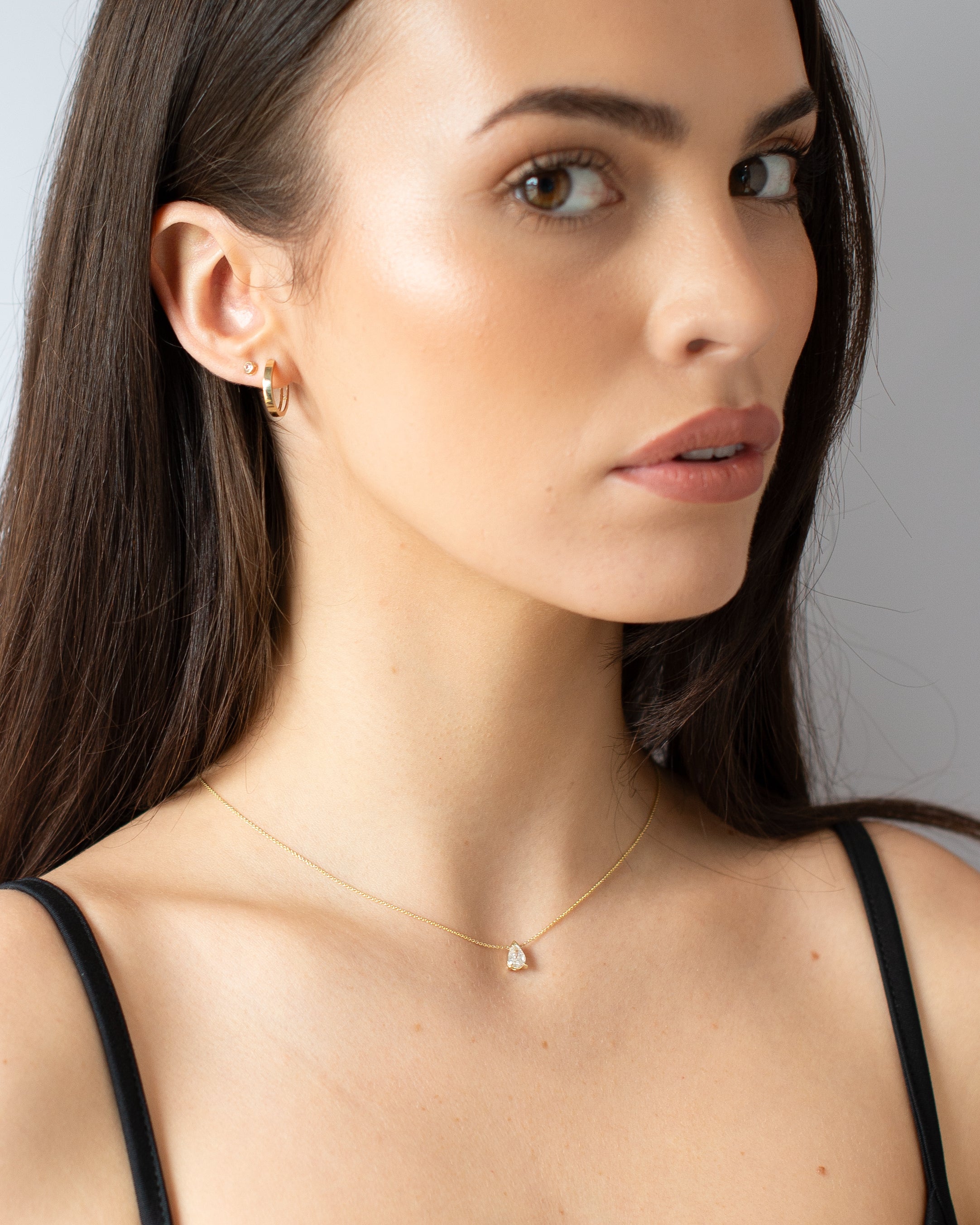 Gold Huggie Essential Earrings model shot