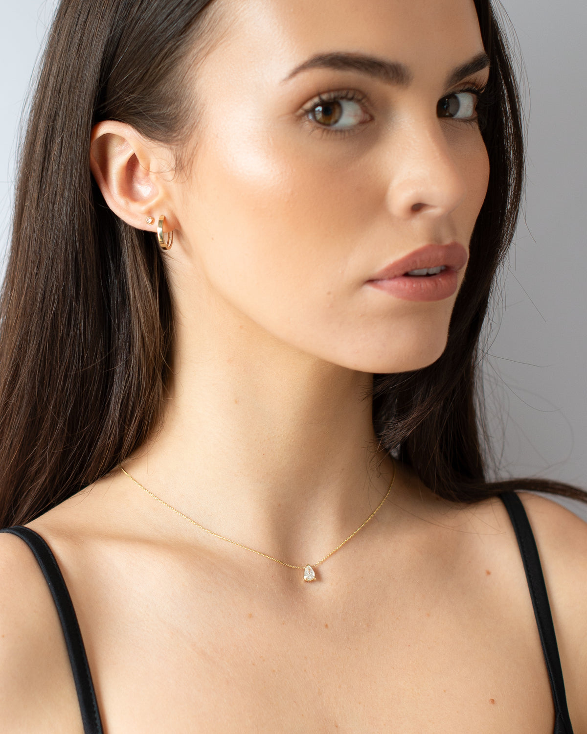 Gold Huggie Essential Earrings model shot