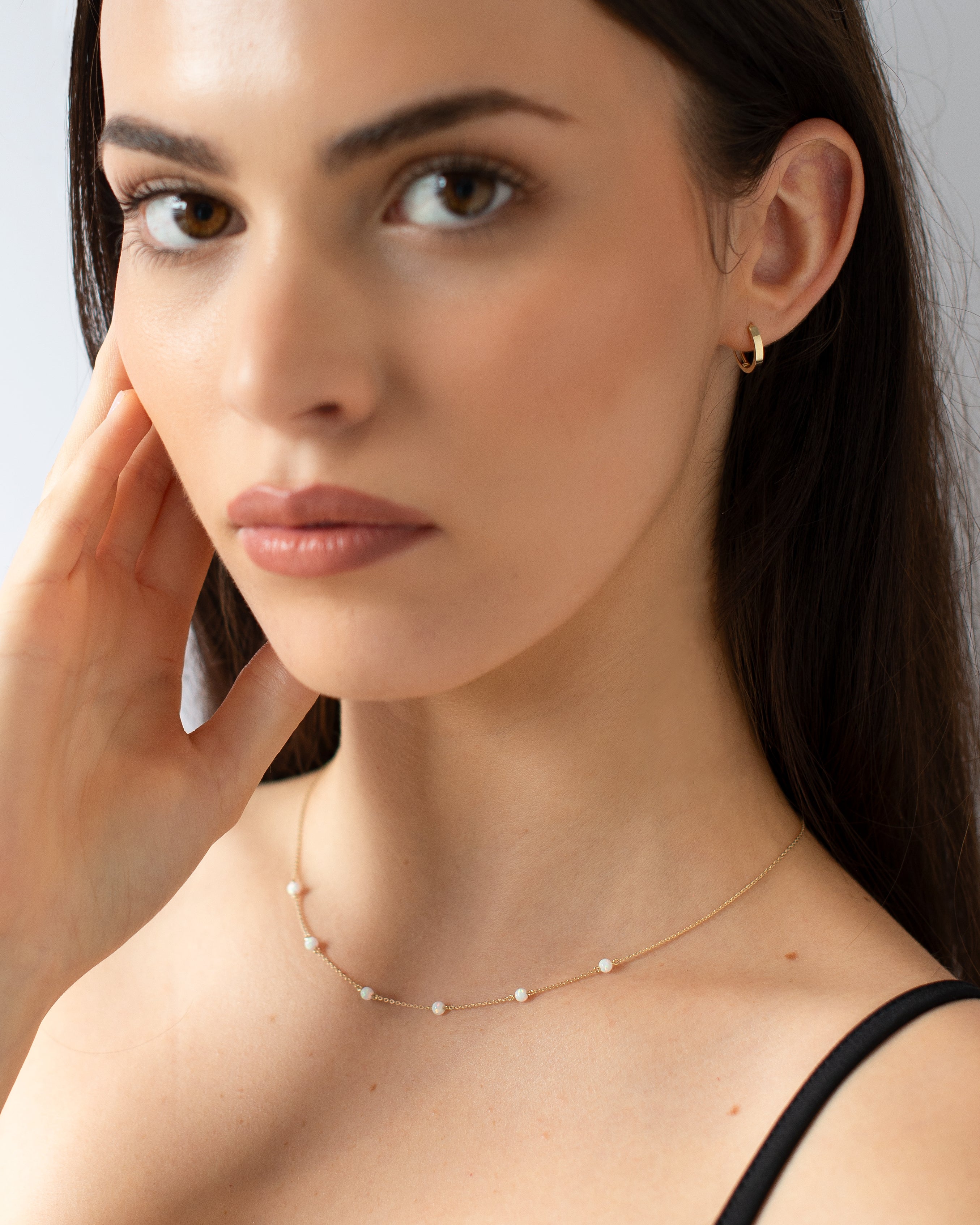 Gold Huggie Essential Earrings model shot