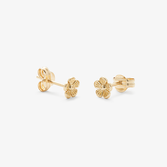 Pair of gold flower-shaped earrings on a white background