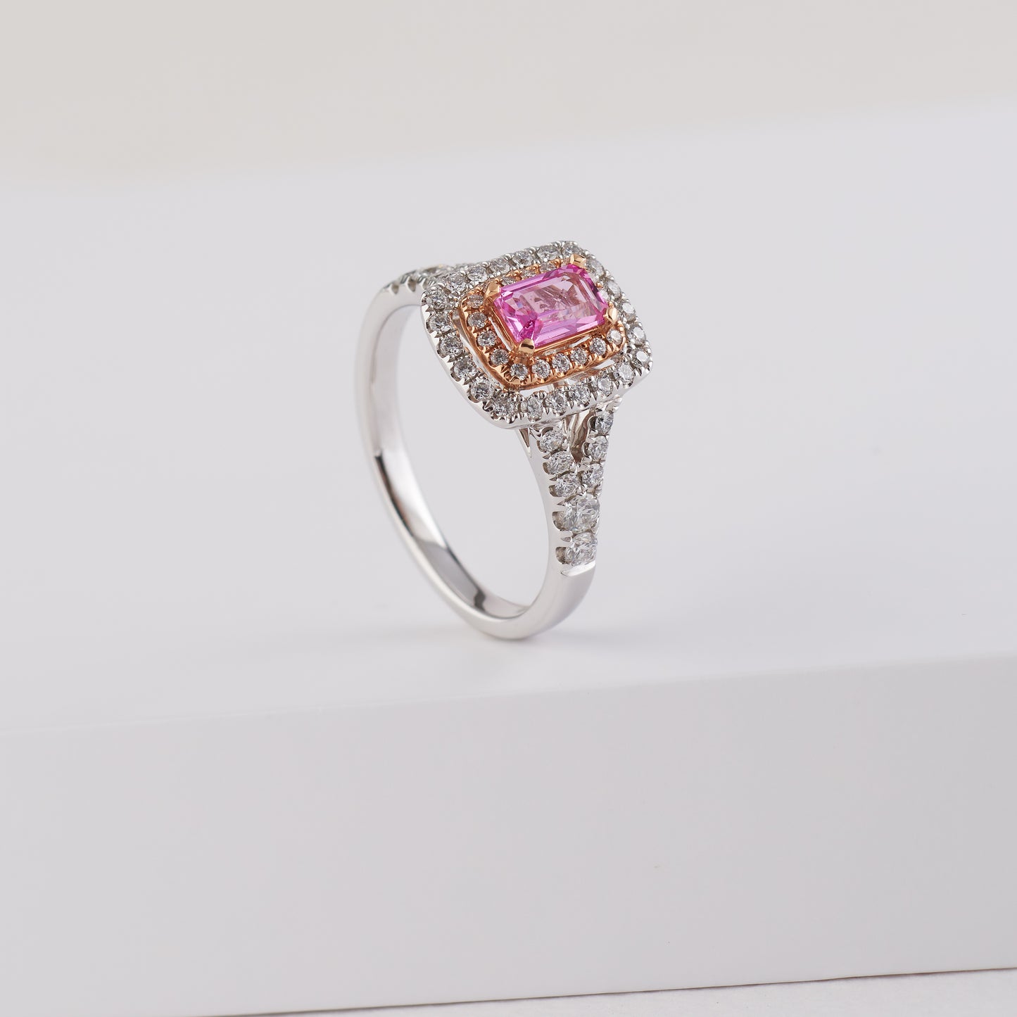 18K White and Rose Gold 6mm x 4mm Emerald Cut Pink Sapphire and Diamond Halo Ring.
